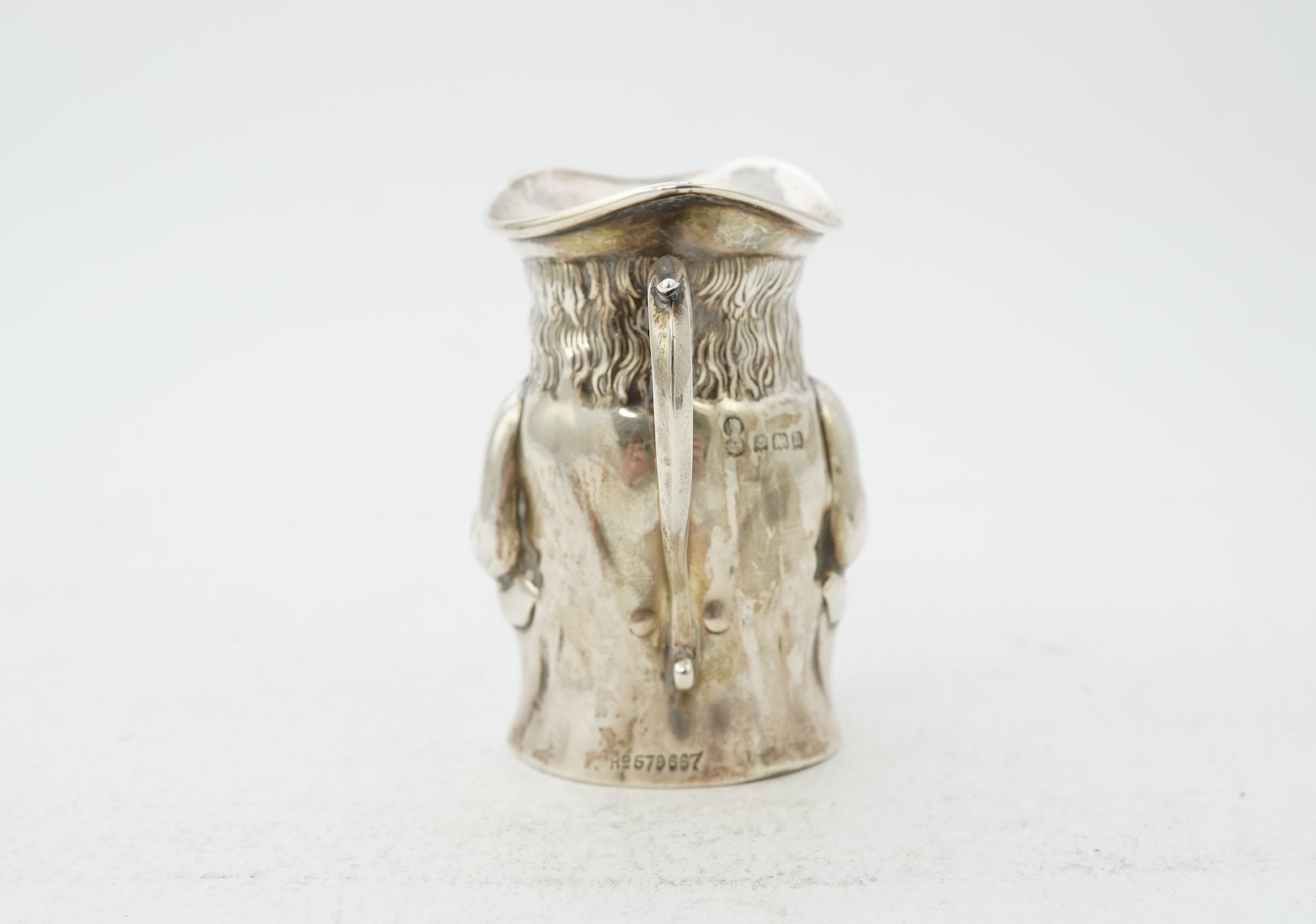 A George V novelty silver cream jug, modelled as a Toby Jug, by Hayes & Co